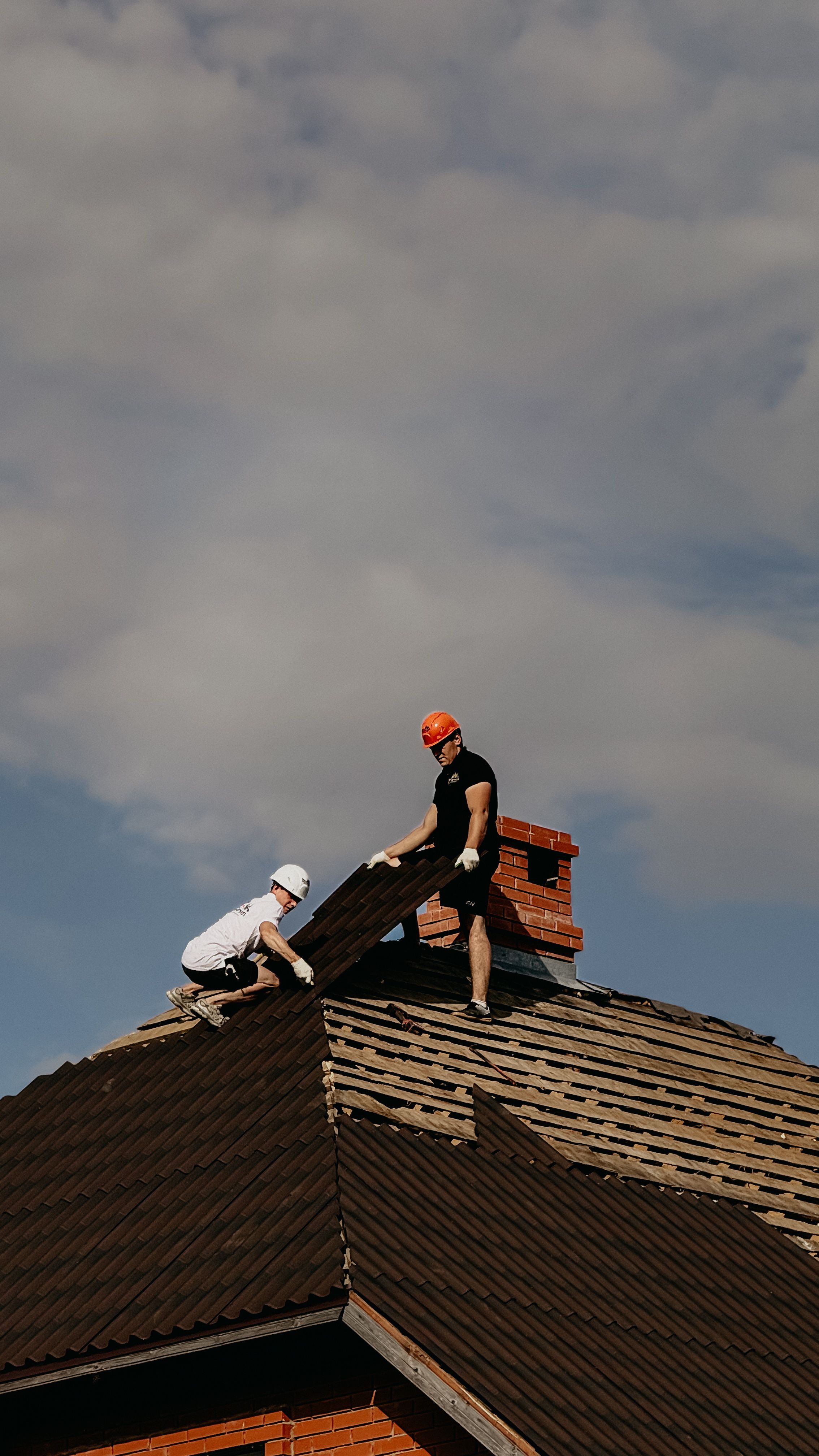 Roof with visible storm damage from fallen tree limbs