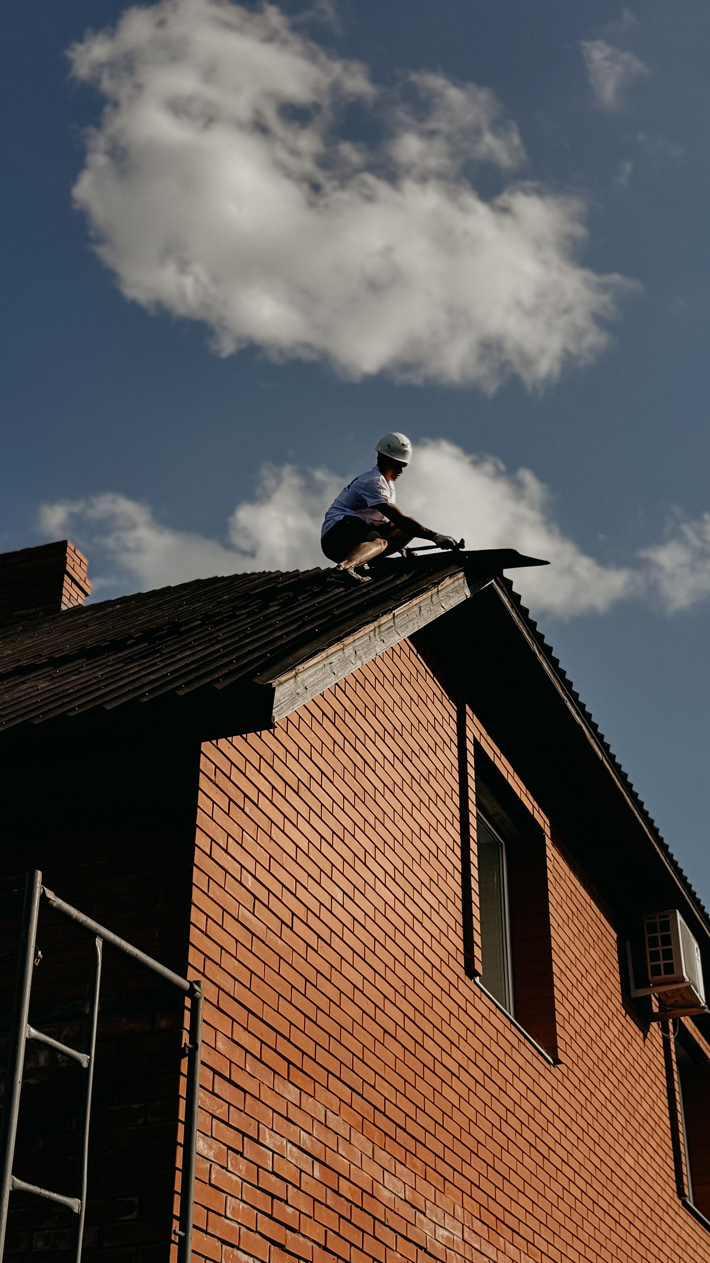 Roof damaged by storm being inspected